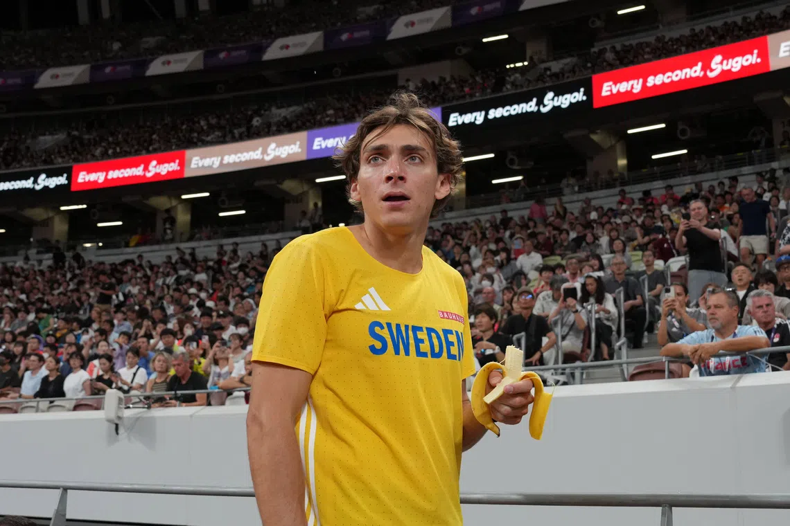Sep 13, 2025; Tokyo, Japan; Mondo Duplantis aka Armand Duplantis (SWE) holds a banana during the pole vault qualifying at the World Athletics Championships at National Stadium. Mandatory Credit: Kirby Lee-Imagn Images