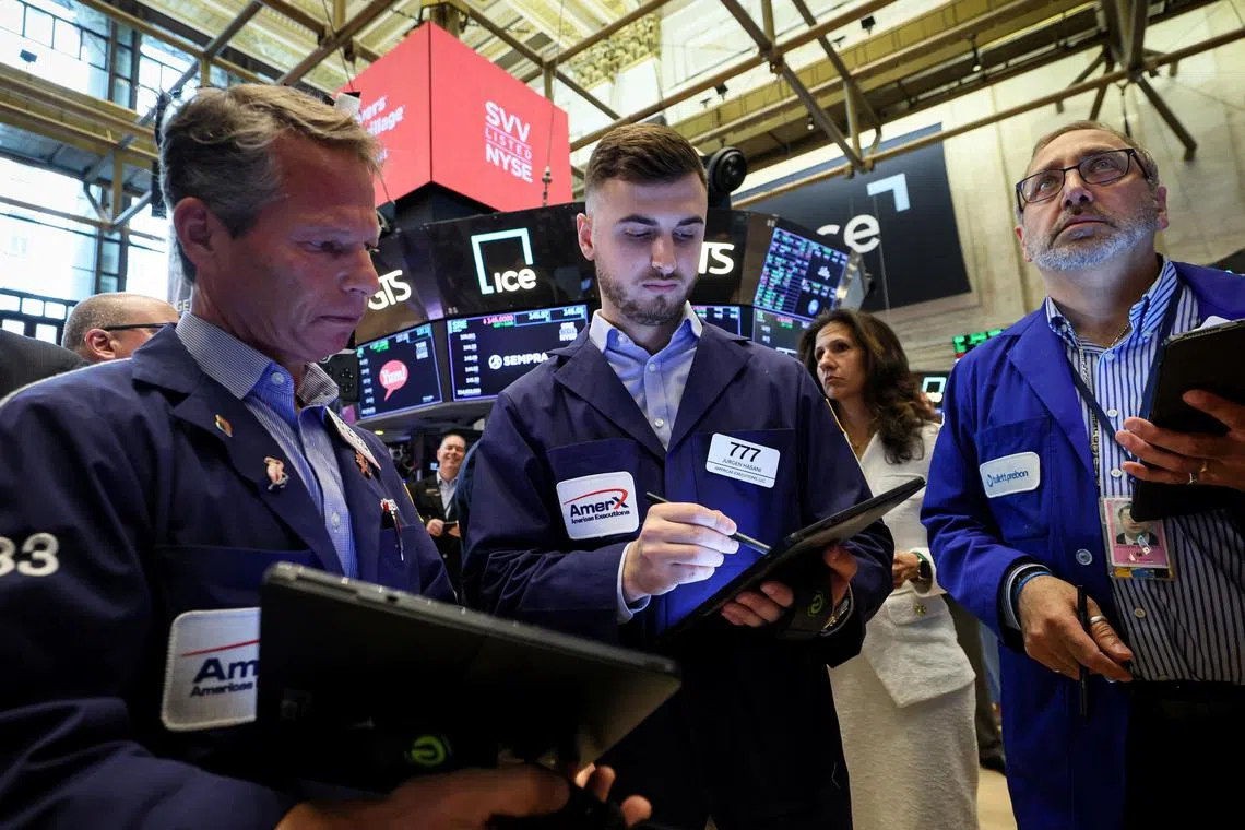 Traders work on the floor of the New York Stock Exchange, in New York City.