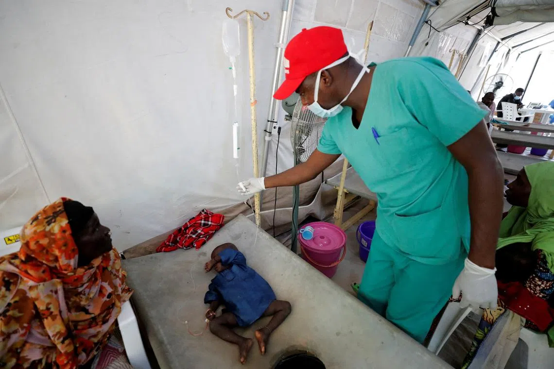 FILE PHOTO: A health worker at the Medecins Sans Frontieres (MSF - Doctors without Borders) Cholera Treatment Center, checks a cholera patient in Maiduguri, Borno State, Nigeria October 18, 2022. REUTERS/Christophe Van Der Perre/File Photo