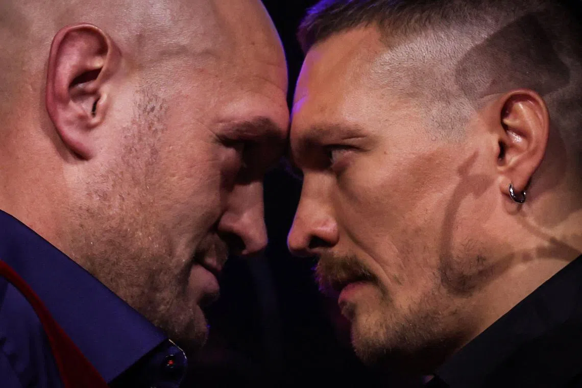 Britain's Tyson Fury (left) and Ukraine's Oleksandr Usyk challenge each other during a press conference in London on November 16, 2023.