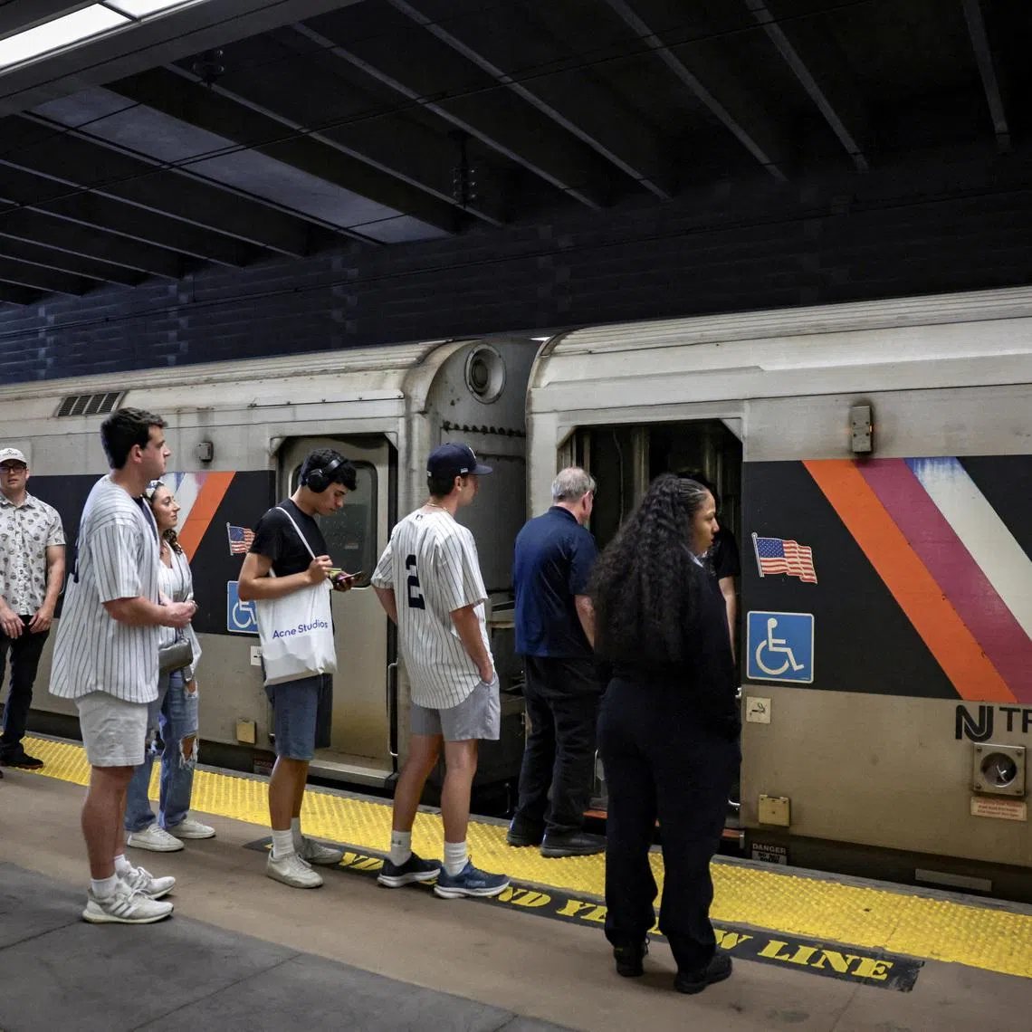 People wait to board a NJ Transit train at the Secaucus Junction station on the day of the announcement of public transit ticket prizes to World Cup games in New Jersey, in Secaucus, New Jersey, U.S., April 17, 2026. REUTERS/Jeenah Moon