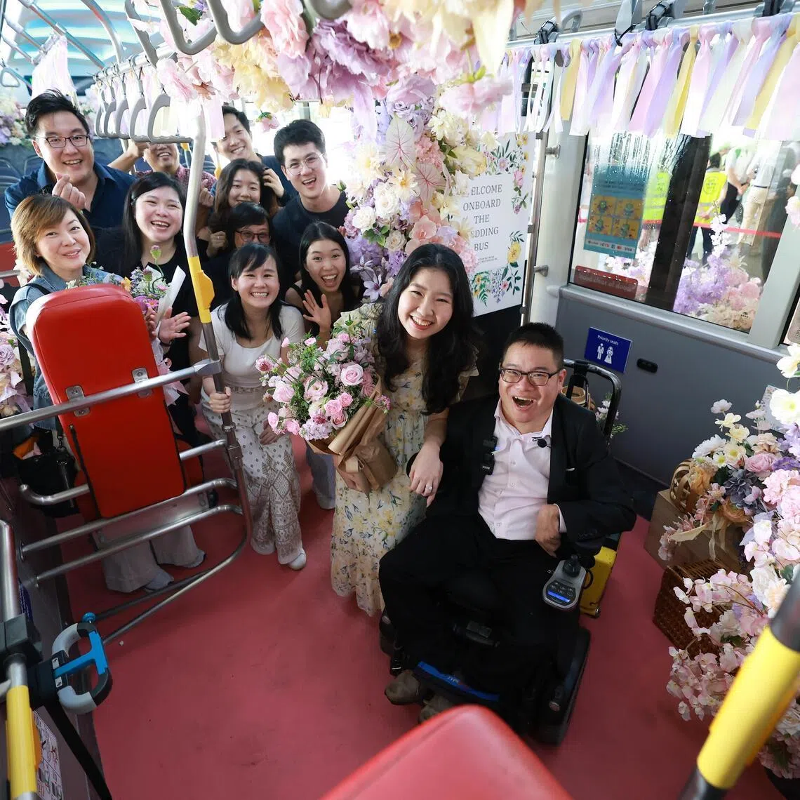 Alister Ong and Jasmine Kurniawan celebrating the marriage proposal on board Tower Transit’s wedding bus.