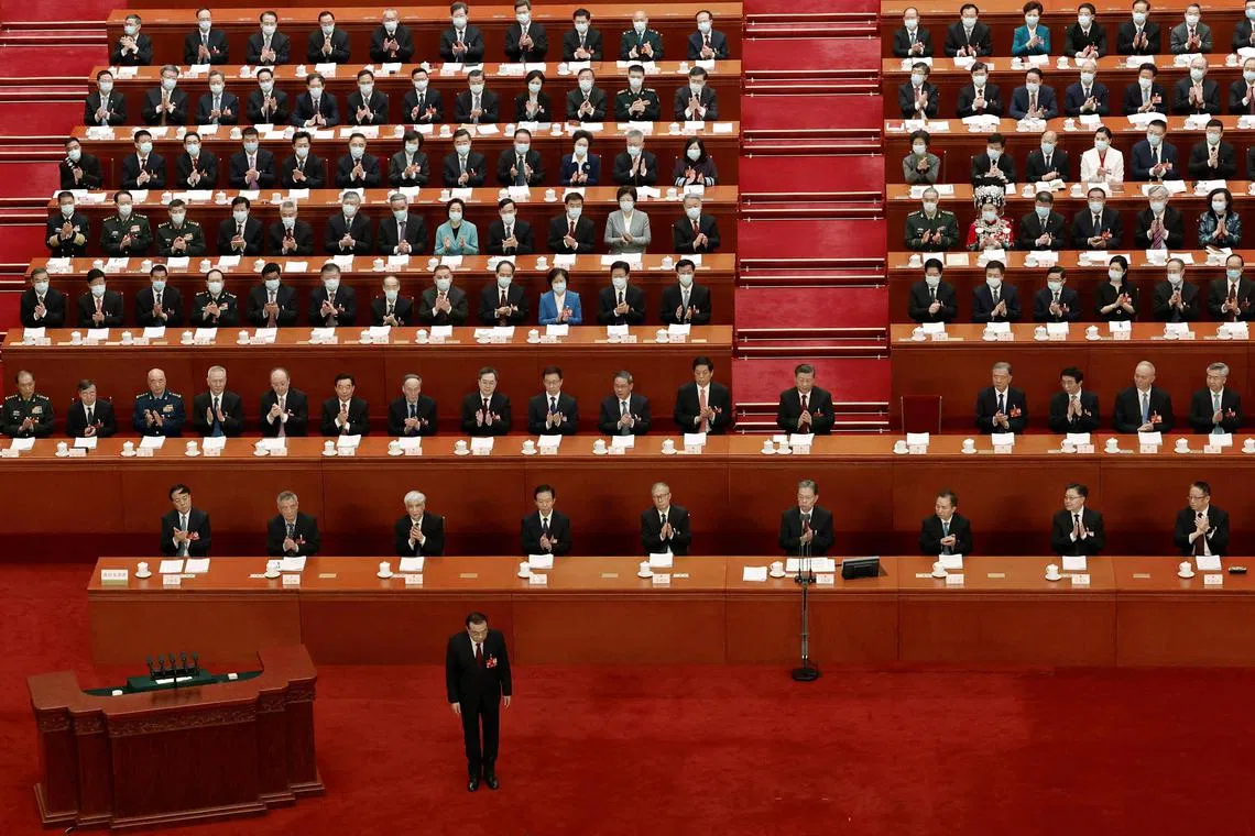 Chinese Premier Li Keqiang bows before delivering the work report at the opening session of the National People's Congress (NPC) at the Great Hall of the People in Beijing, China March 5, 2023. REUTERS/Thomas Peter