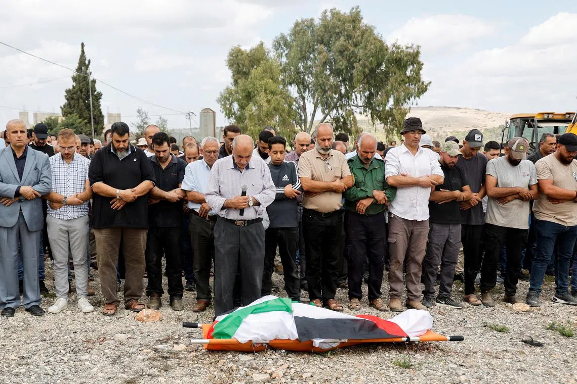 Mourners bid farewell to 60-year-old Palestinian woman, Hanan Salameh, who was shot by Israeli forces during olive harvest, according to Palestinian health ministry, in the village of Faqqua, during her funeral near Jenin, in the Israeli-occupied West Bank, October 17, 2024. REUTERS/Raneen Sawafta