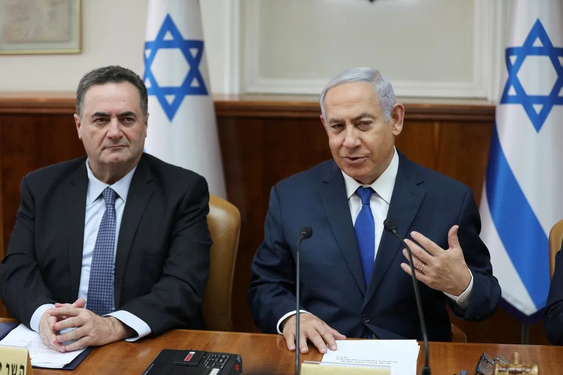 FILE PHOTO: Israeli Prime Minister Benjamin Netanyahu sits next to acting foreign minister Israel Katz, who also serves as intelligence and transport minister, during the weekly cabinet meeting in Jerusalem February 24, 2019. Abir Sultan/Pool via REUTERS/File Photo