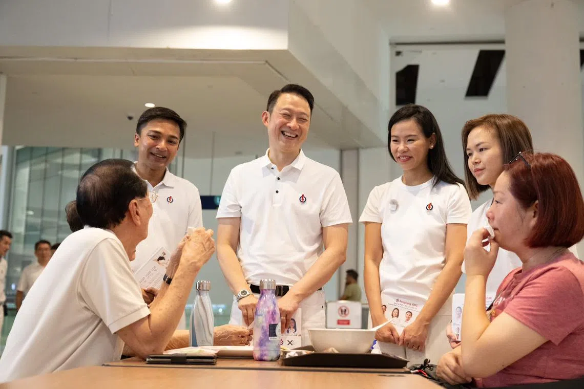 PAP's Sengkang GRC candidates Elmie Nekmat, Lam Pin Min, Bernadette Giam and Theodora Lai chatting with residents at Buangkok Hawker Centre.