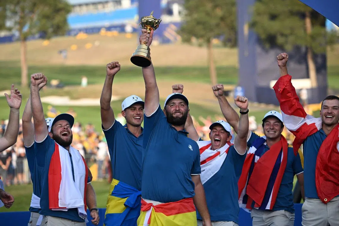 Europe's Spanish golfer, Jon Rahm (centre) cheering with The Ryder Cup and his teammates at the presentation ceremony in Rome in October.