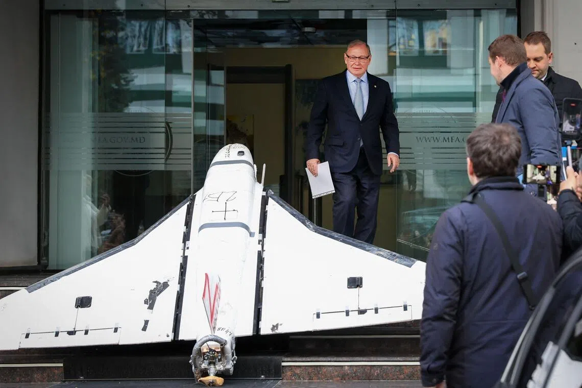 Russian ambassador to Chisinau Oleg Ozerov passing a Russian-made Gerbera drone on Nov 26 after it was placed at the entrance to the Ministry of Foreign Affairs.