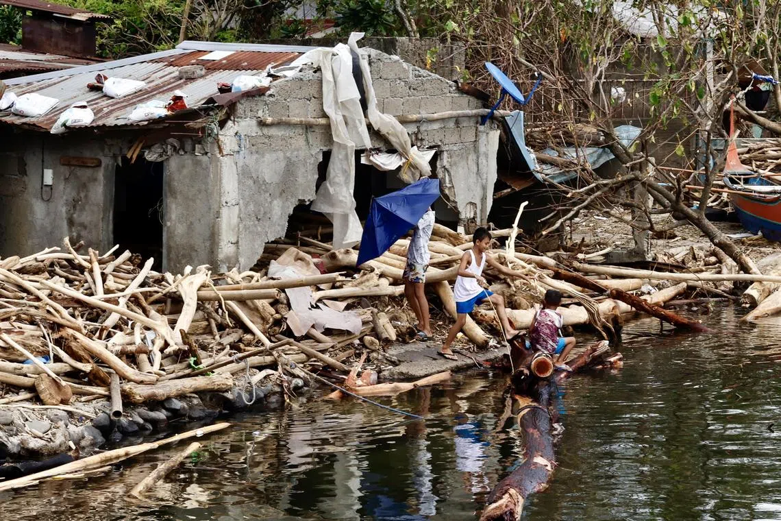 epa11698487 Villagers are seen next to a damaged home amongst debris in the aftermath of the recent typhoons in the town of Balete, Batangas province, Philippines, 03 November 2024. Typhoons Trami and Kong-rey killed more than 145 people and injured hundreds more, damaging hundreds of roads, the National Disaster Risk Reduction and Management Council (NDRRMC) said on 03 November. Amidst the Philippines' recovery period, the government weather bureau issued the latest forecast of another typhoon developing in the eastern part of the country within the next 24 hours.  EPA-EFE/FRANCIS R. MALASIG
