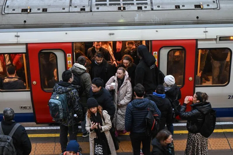 Commuters on the platform at Earls Court Tube station in London.  