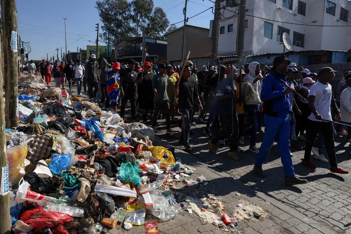 People march as anti-immigrant protesters go door-to-door in search of undocumented foreign nationals to take them to the police, after an unofficial June 30 deadline set by anti-immigrant groups for undocumented migrants to leave the country had passed, in Alexandra township, South Africa, July 9, 2026. REUTERS/Oupa Nkosi