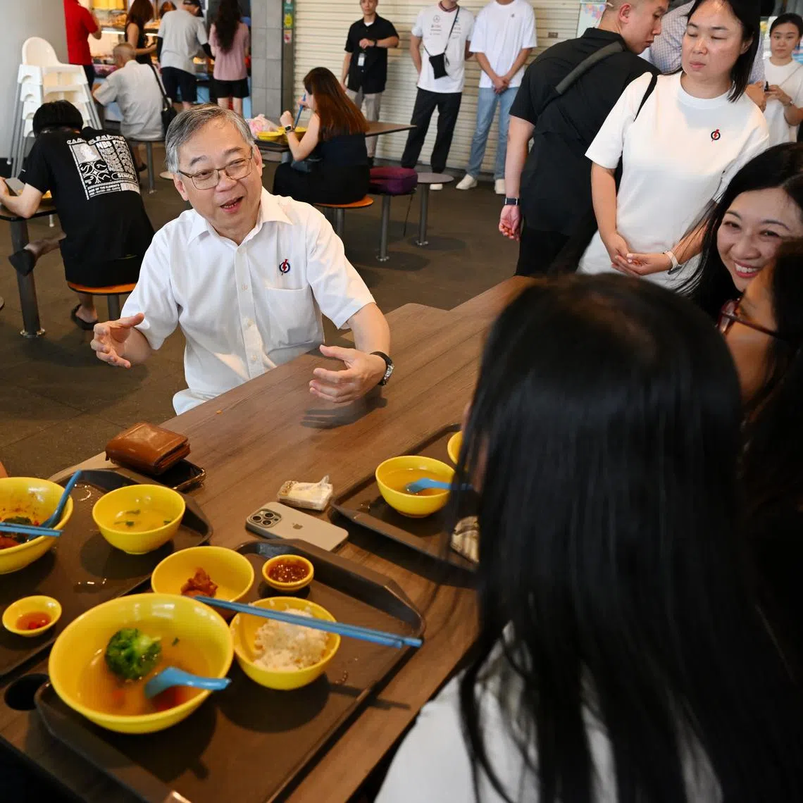 DPM Gan Kim Yong speaking to residents during a walkabout at One Punggol Hawker Centre on April 29.