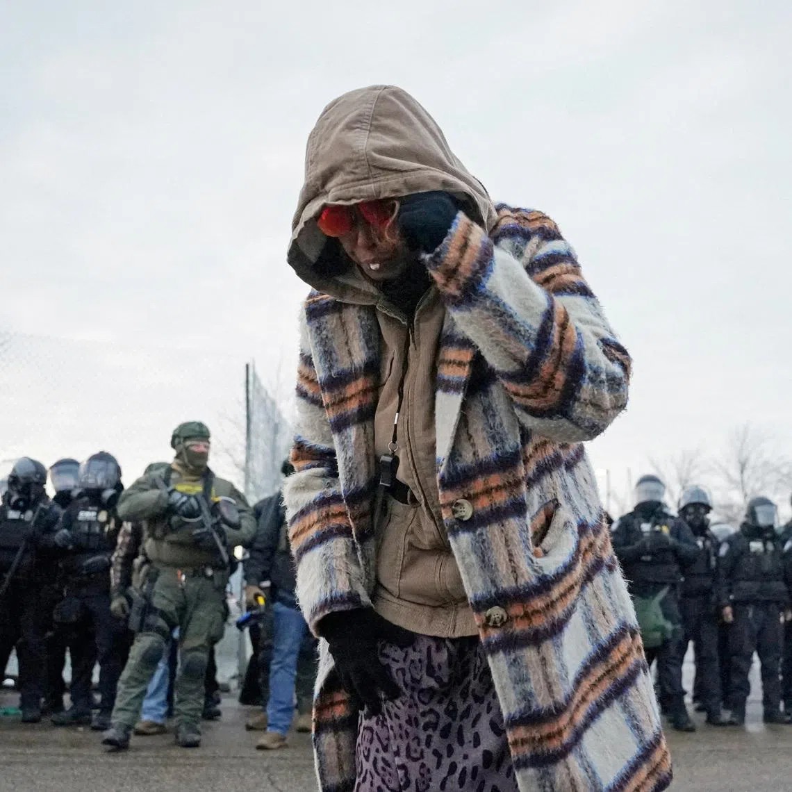 A woman struck by pepper balls during a protest more than a week after a US ICE agent fatally shot Ms Renee Nicole Good, in Minnesota, on Jan 17.