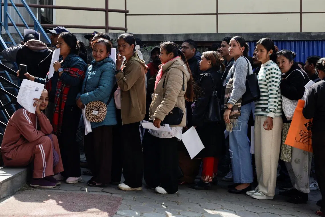 People planning to leave the country and apply for foreign employment in search of better opportunities queue as they prepare for an interview at Motherland Overseas, a recruitment agency, as Nepal's biggest political parties vow to fix the outflow of workers ahead of the elections of the House of Representatives scheduled for March 5, triggered by historic youth-led protests fuelled by the lack of jobs and endemic corruption that forced an elected prime minister to resign, in Kathmandu, Nepal, February 22, 2026. REUTERS/Navesh Chitrakar