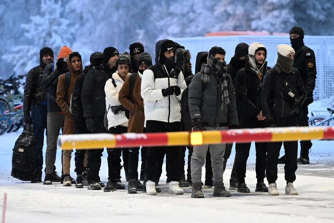 Migrants arrive at Finland's border crossing with Russia, at Salla, northern Finland.