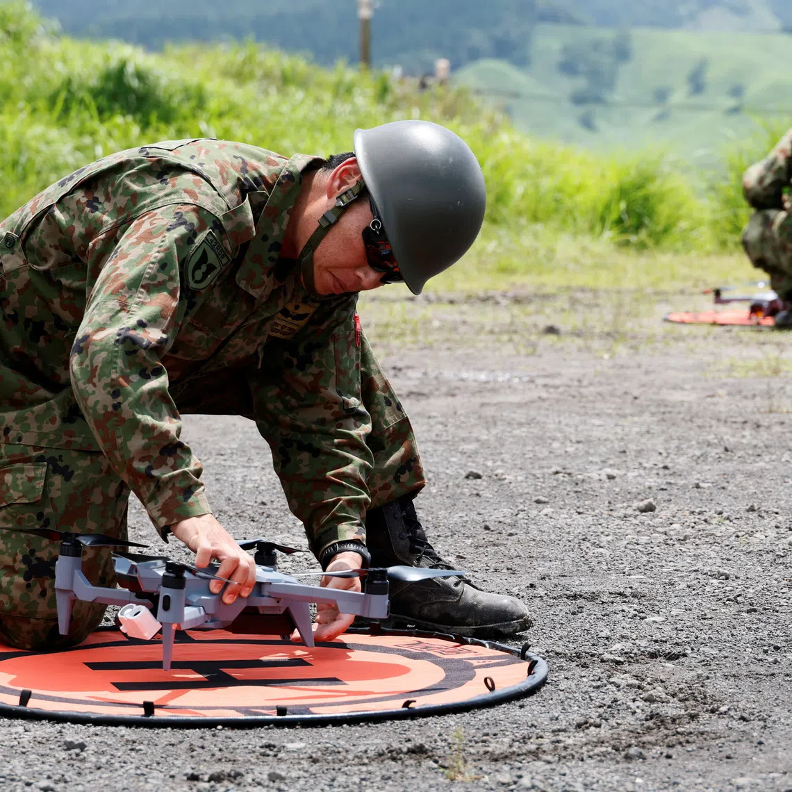 Members of the Japanese Self-Defence Force checkIng SOTEN drones during a joint live-fire drill with US Marines in Japan on June 28.