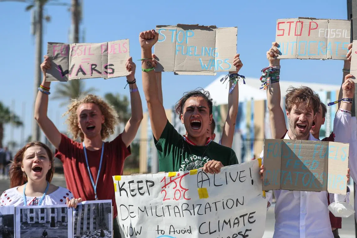 Climate activists hold banners and shouts slogans as they  attends a  protest against fossil fuels during the 2022 COP27 in Sharm El-Sheikh, Egypt on Nov 12. 