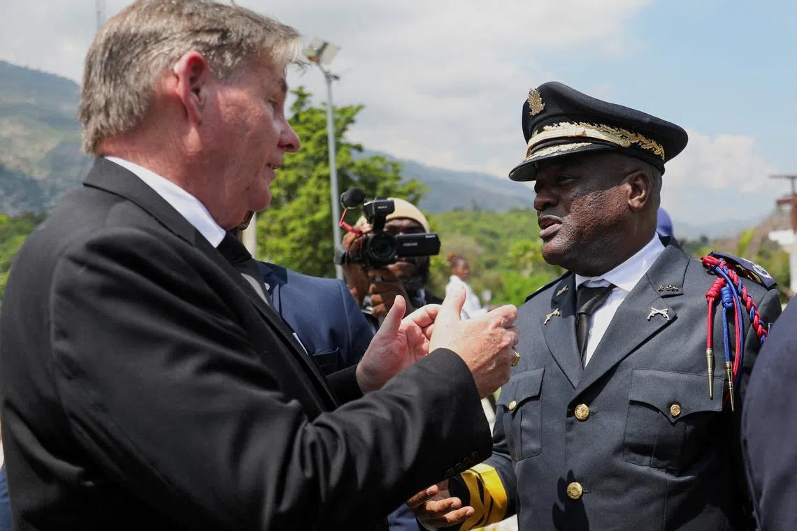 FILE PHOTO: U.S. ambassador to Haiti, Dennis Hankins talks with Police Chief Frantz Elbe after Haiti’s transitional council ceremony, on the outskirts of Port-au-Prince, Haiti April 25, 2024. REUTERS/Ralph Tedy Erol/File Photo