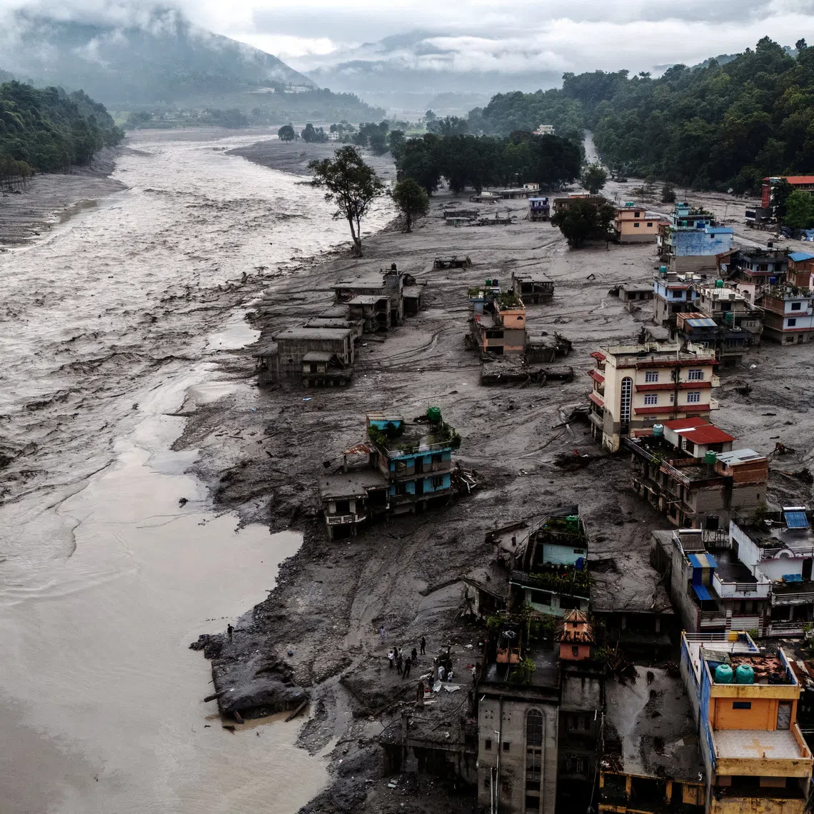 A drone view shows damaged buildings and houses covered in mud next to the Likhu River on Aug 30, following deadly flash floods and mudslides, in Devighat, Nepal’s Nuwakot district.