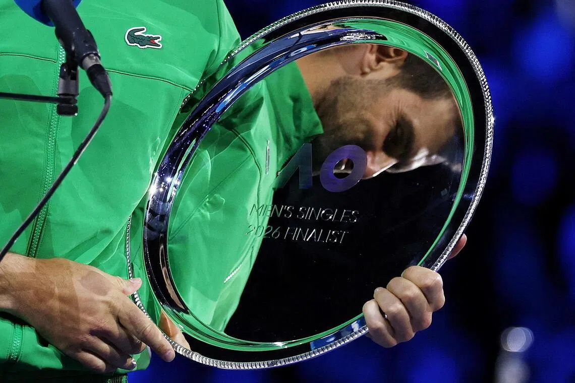 Novak Djokovic, 10-time champion at the Australian Open, holding a rare piece of silver: The runner's up trophy. 