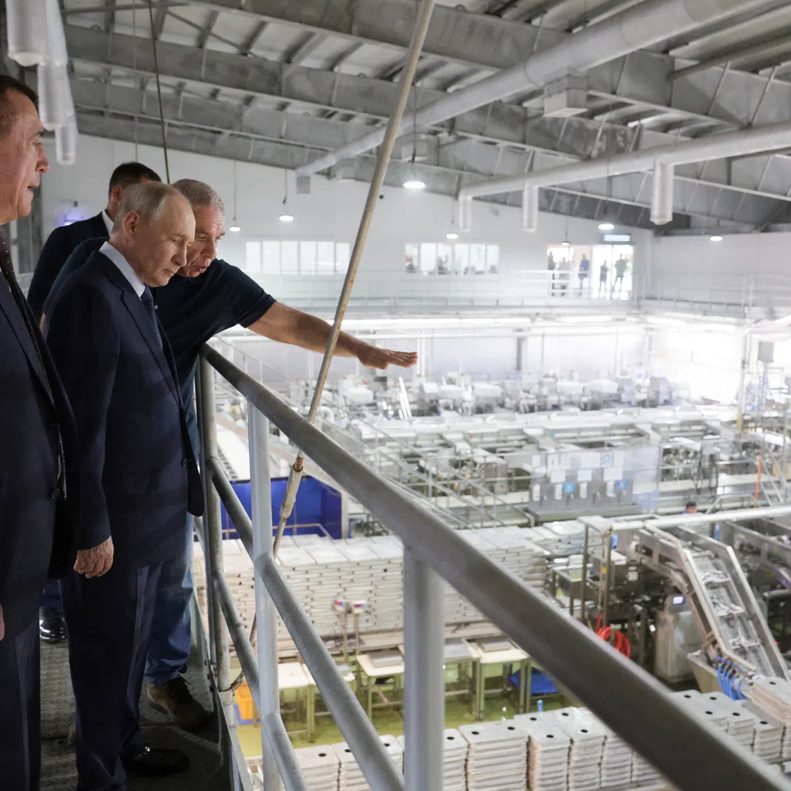 Russian leader Vladimir Putin visiting a fish processing plant on Iturup, one of the islands that Japan also claims as its territory.