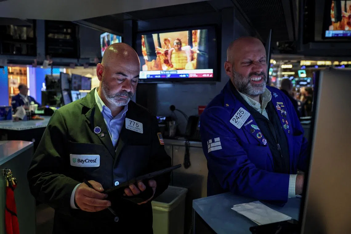 Traders work on the floor of the New York Stock Exchange, in New York City.