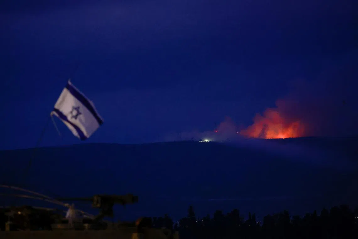 Flame and smoke rising over Lebanon as seen from Israel's border with Lebanon, in northern Israel on Oct 10.