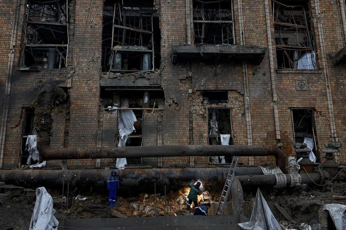 Workers repair a pipe at a compound of Darnytsia Thermal Power Plant which was heavily damaged by recent Russian missile and drone strikes.