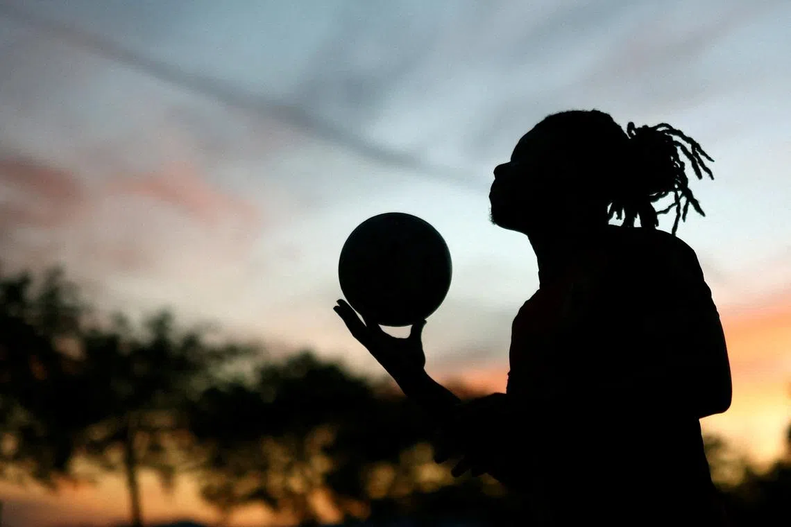 FILE PHOTO: Soccer Football - FIFA World Cup 2026 - Sunset Beach FC holds a street football match - Sunset Beach, Vancouver, Canada - June 22, 2026 A player participates in the community run weekly street football held at a asphalt hockey rink  REUTERS/Lee Smith/File Photo