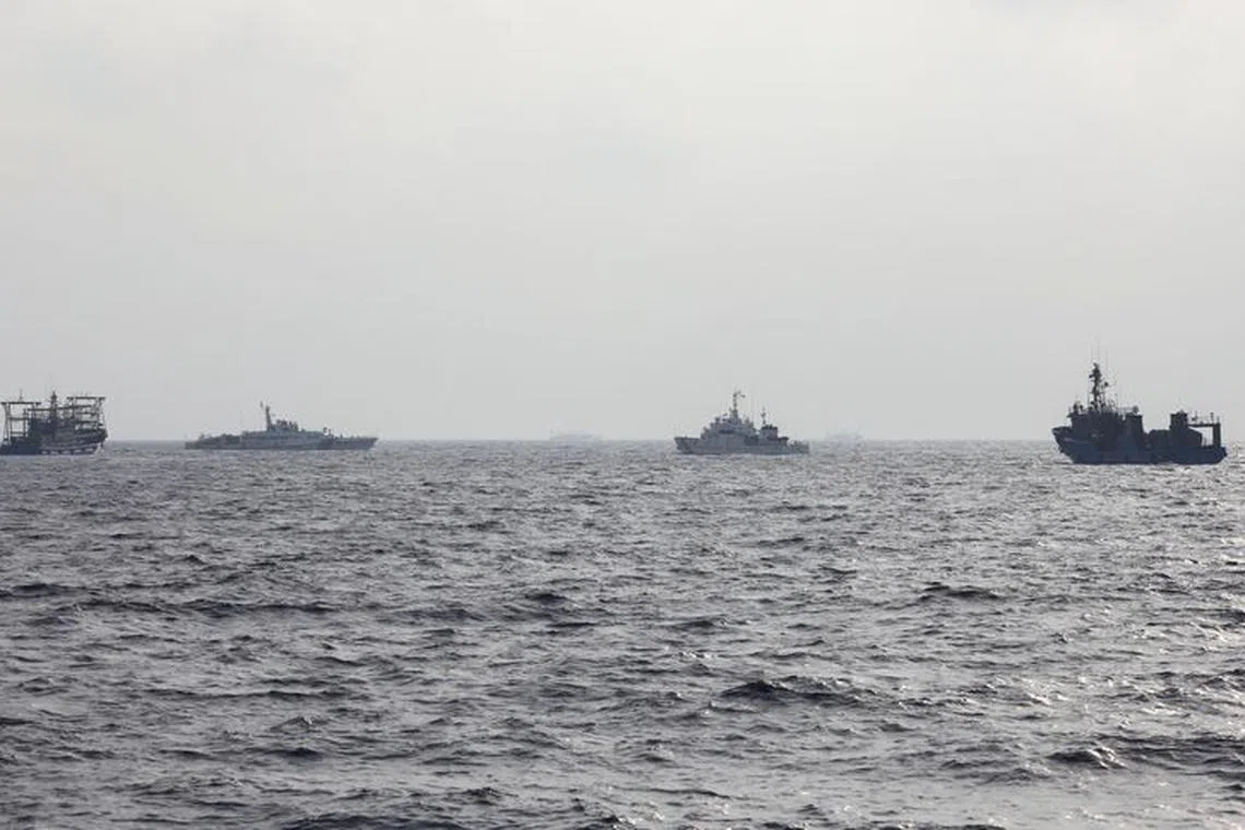 A Philippine Coast Guard ship is seen surrounded by Chinese maritime militia vessels and a Chinese Coast Guard ship during a resupply mission for Filipino troops stationed at a grounded warship in the South China Sea, October 4, 2023. REUTERS/Adrian Portugal/File Photo