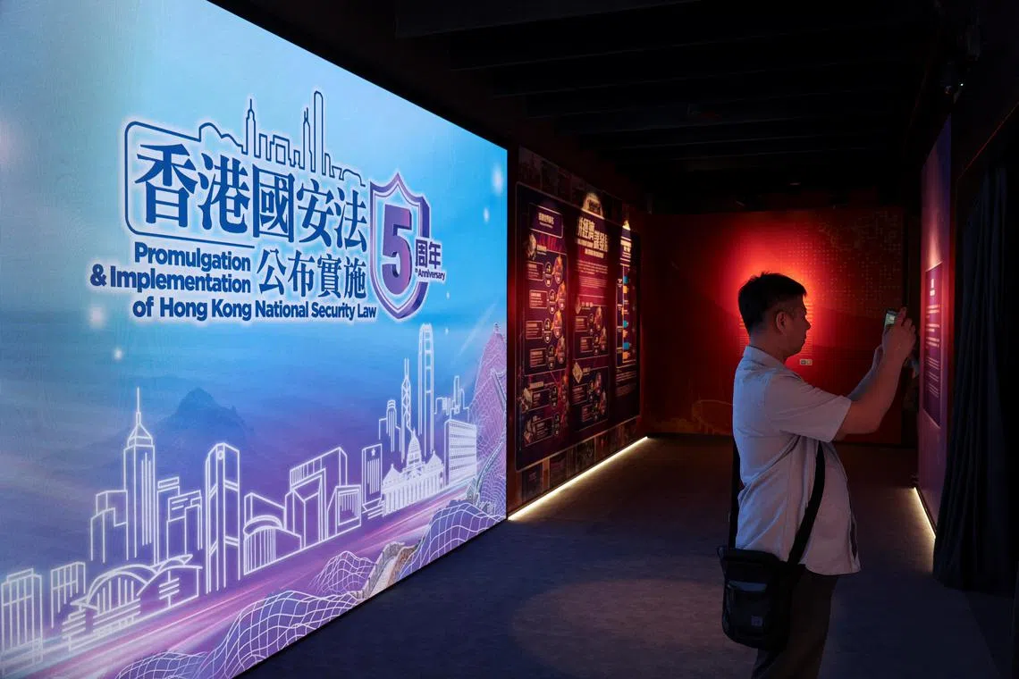 A visitor takes photos at the National Security Exhibition Gallery ahead of the fifth anniversary of the national security law in Hong Kong, on June 20.