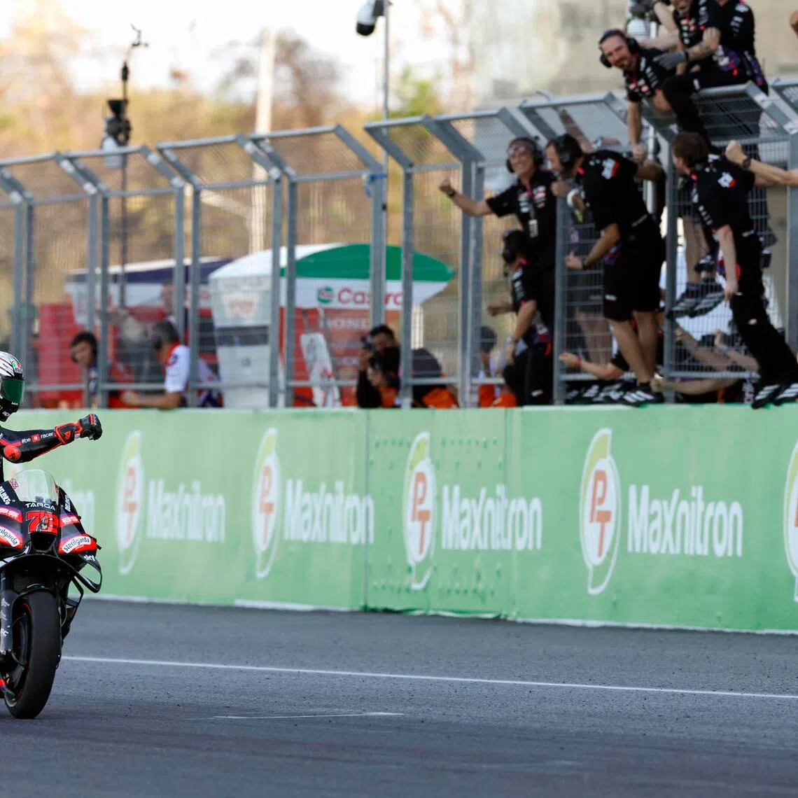 Italian Marco Bezzecchi of Aprilia Racing celebrates with his team after winning the MotoGP Grand Prix of Thailand at Chang International Circuit, Buriram province on March 1, 2026.