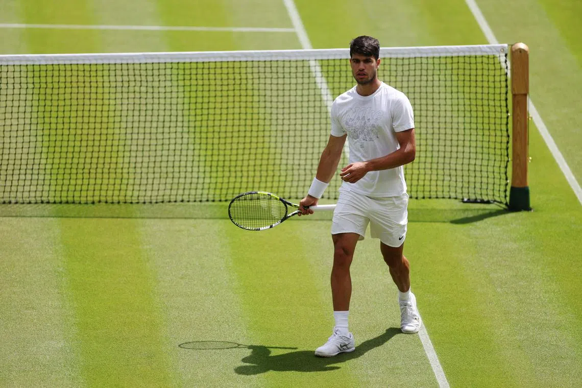 FILE PHOTO: Tennis - Wimbledon Preview - All England Lawn Tennis and Croquet Club, London, Britain - June 27, 2024 Spain's Carlos Alcaraz during a practice session on centre court with Russia's Daniil Medvedev REUTERS/Paul Childs