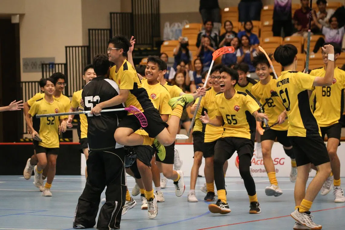 Victoria School floorball players celebrate winning the B Division Boys' final against St. Gabriel's Secondary School.