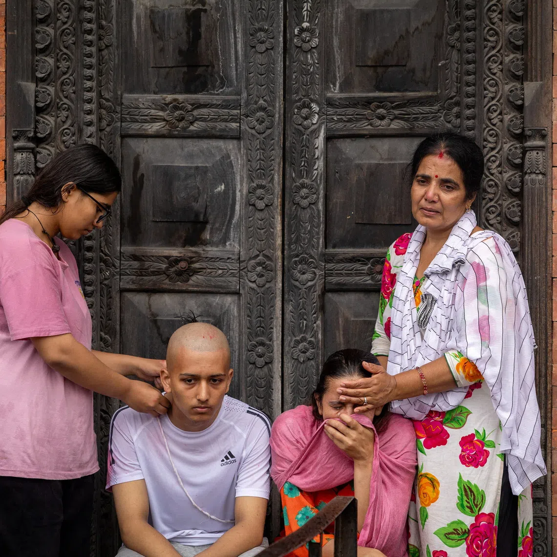 Kamala Bhattarai and Darshan Bhattarai, the wife and son of Pushpa Raj Bhattarai, 46, who died in deadly flash floods and a mudslide, mourn during his cremation ceremony using an effigy because the body remains missing, at Pashupatinath Temple in Kathmandu, Nepal, September 3, 2026. REUTERS/Adnan Abidi TPX IMAGES OF THE DAY