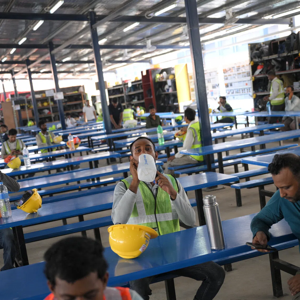 Workers at a sheltered area with insulated roofing at the construction site of the PSA Supply Chain Hub @ Tuas, during a showcase of how heat stress risks are managed.