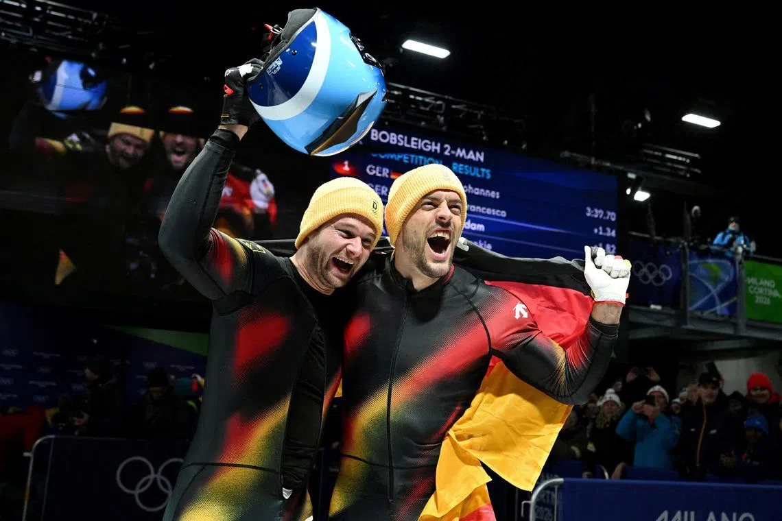 Milano Cortina 2026 Olympics - Bobsleigh - 2-man Heat 4 - Cortina Sliding Centre, Cortina d'Ampezzo, Italy - February 17, 2026. Johannes Lochner of Germany and Georg Fleischhauer of Germany celebrate after winning the gold medal. REUTERS/Annegret Hilse