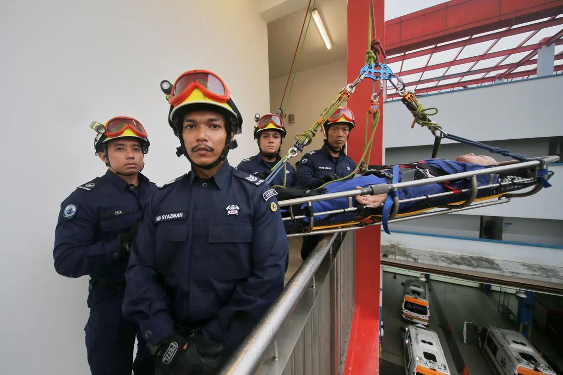 (From left) SCDF Dart specialists WO1 Isa Endin, SGT3 Mohammad Syazwan, SGT3 Ana Shaik Ashraf and their section commander WO1 Mohd Azlan.