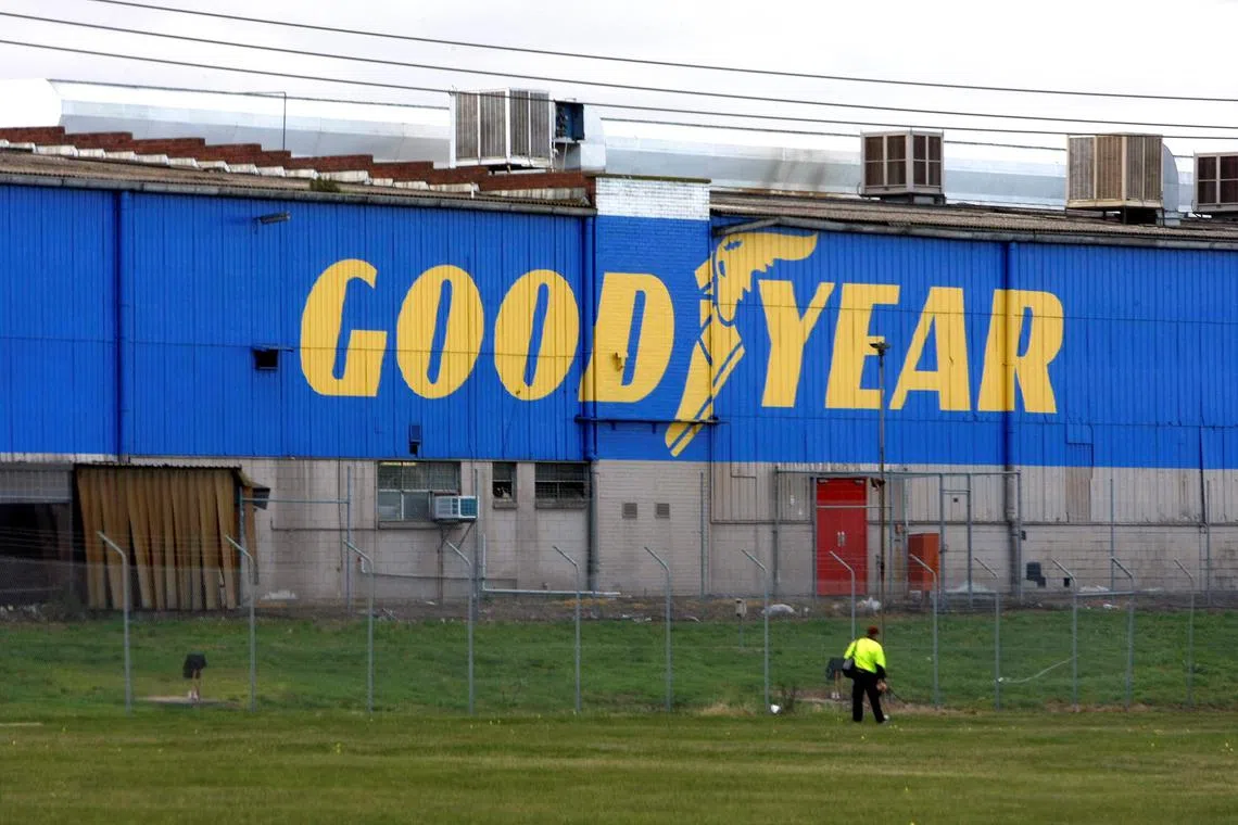 FILE PHOTO: A man walks past the Goodyear logo at the South Pacific Tyres facility in Somerton, Victoria, about 20km from Melbourne, June 26, 2008.  REUTERS/Mick Tsikas   (AUSTRALIA)/File Photo