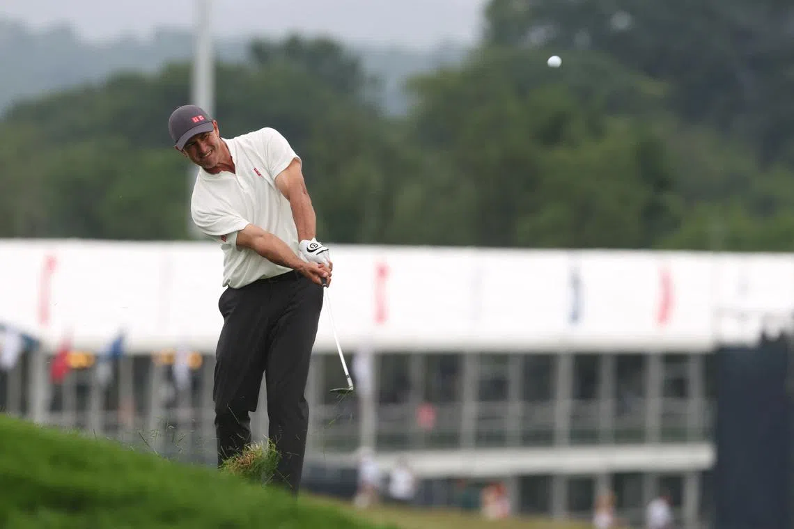 FILE PHOTO: Jun 15, 2025; Oakmont, Pennsylvania, USA; Adam Scott hits from the rough on the 14th hole during the final round of the U.S. Open golf tournament. Mandatory Credit: Charles LeClaire-Imagn Images/File Photo