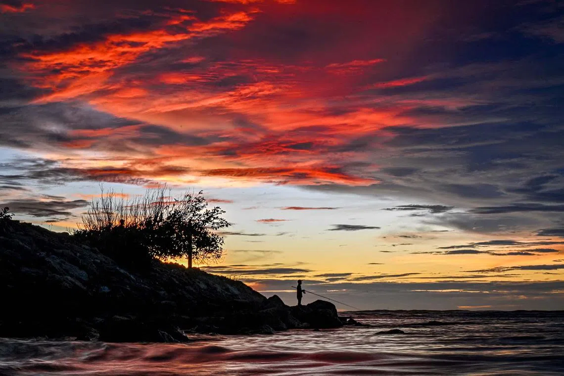 A man fishing during sunset at Lhoknga beach in Aceh province in Indonesia on Nov 6, 2024.