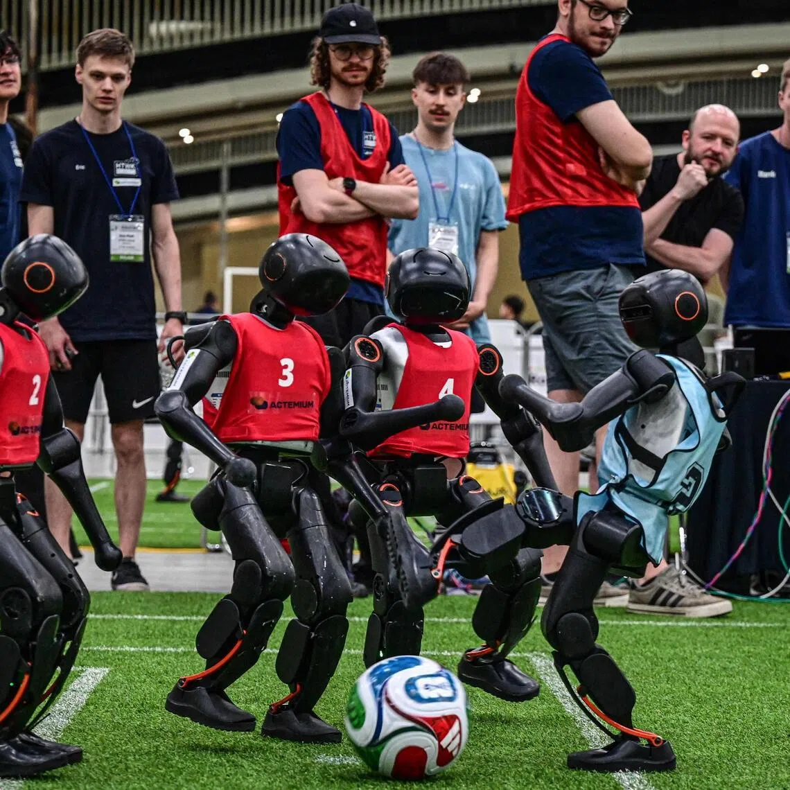 TOPSHOT - Robots take part in a football match at RoboCup 2026, a robotics and Artificial Intelligence (AI) competition in Incheon on July 3, 2026. (Photo by Jade GAO / AFP)