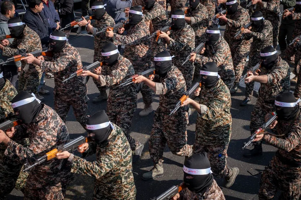 Islamic Revolutionary Guard Corps armed personnel wear masks and participate in a military rally in downtown Tehran, Iran, on January 10, 2025