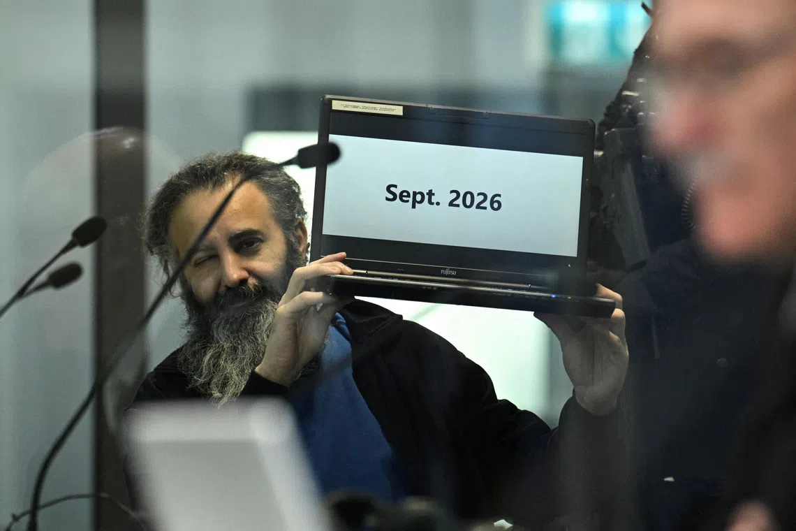 Suspect Taleb al-Abdulmohsen, a 51-year-old doctor from Saudi Arabia, who is facing charges of murder, attempted murder and dangerous interference with road traffic, shows a laptop with the text "Sept. 2026", at the opening of the Magdeburg Christmas market attack trial, at a regional court in Magdeburg, Germany on Nov 10, 2025. 