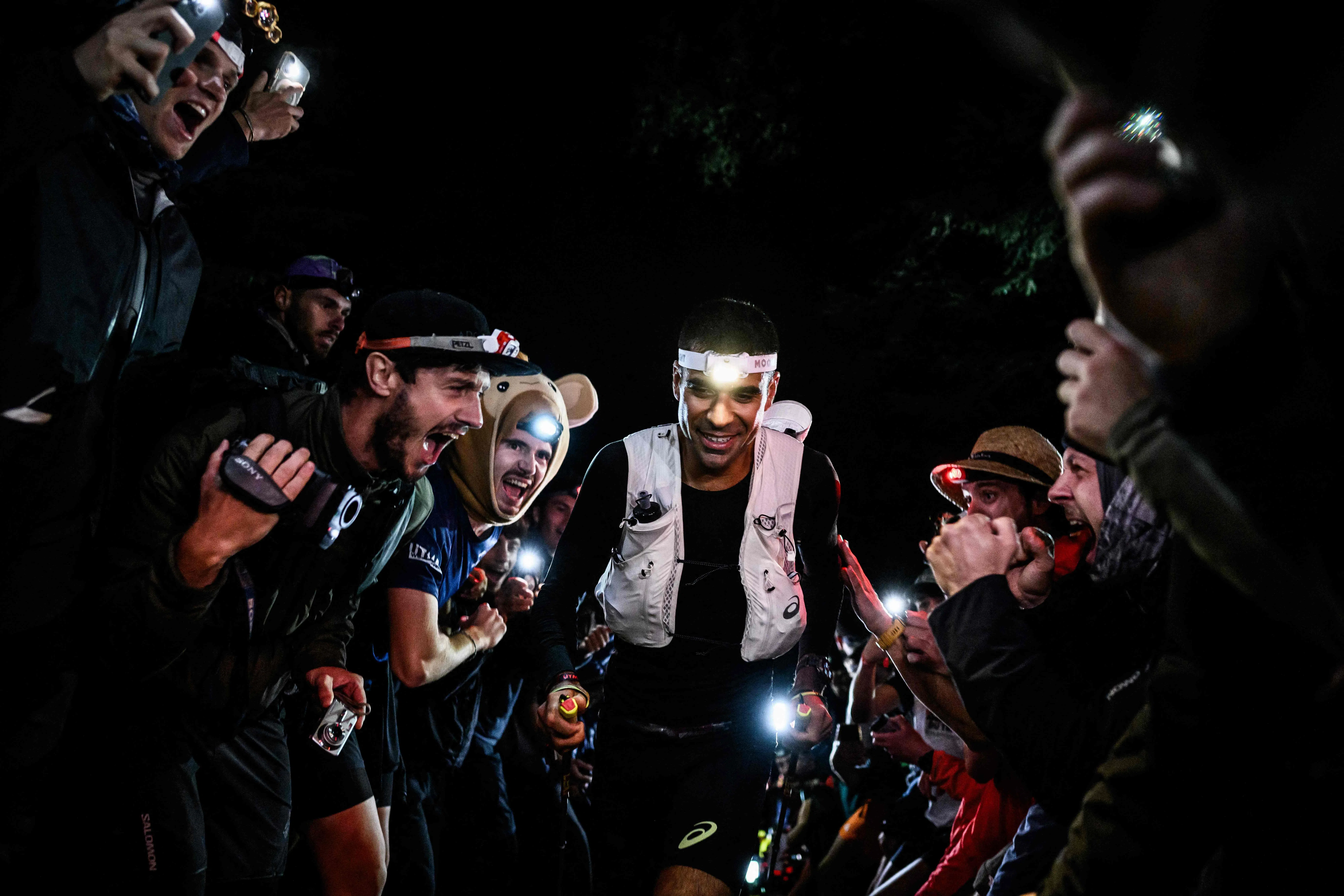 TOPSHOT - US trail runner Ben Dhiman competes in the 23rd edition of the Ultra Trail du Mont Blanc (UTMB), a 174km trail race crossing France, Italy and Switzerland in Chamonix, south-eastern France on August 28, 2026. (Photo by JEFF PACHOUD / AFP)