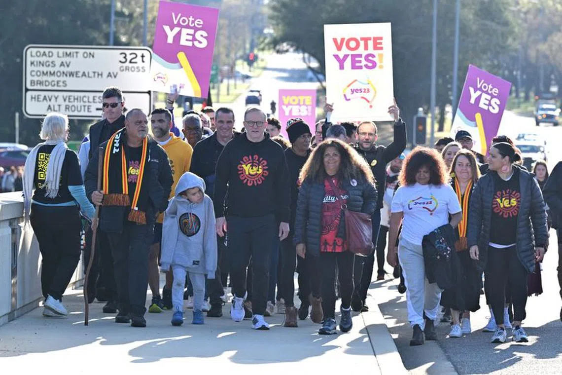 Australian Prime Minister Anthony Albanese and former AFL player Michael Long walk to Parliament House at the completion of a 20-day long walk for the Yes campaign, in Canberra, Australia September 14, 2023. AAP Image/Mick Tsikas via REUTERS
