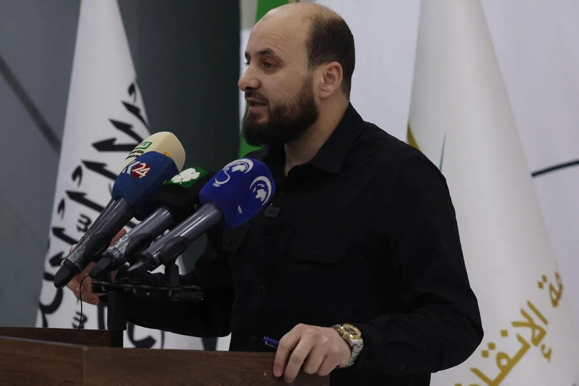 Mr Mohammad al-Bashir delierving a press briefing in the northwestern Syrian city of Idlib on Nov 28. 