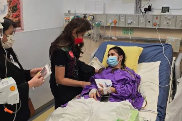 Philippine Senator Imee Marcos is seen in this handout photo visiting domestic helper Rhodora Alcaraz at a hospital in Hong Kong.