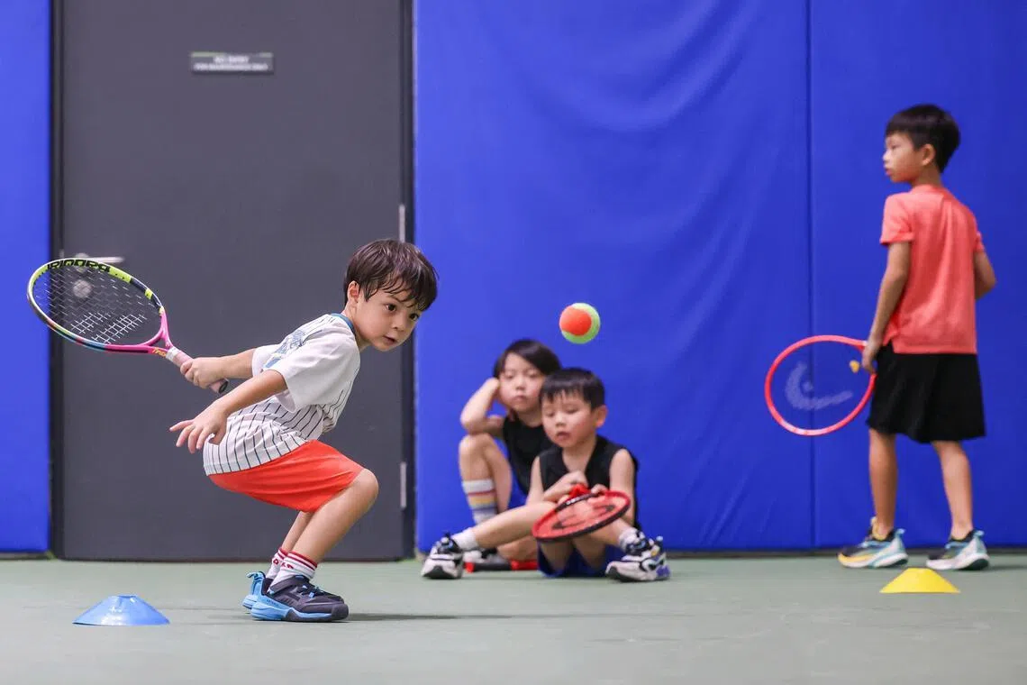 Liam Goh, 4, practising his swing during the Kallang Kids Tennis Camp at the Kallang Tennis Hub.