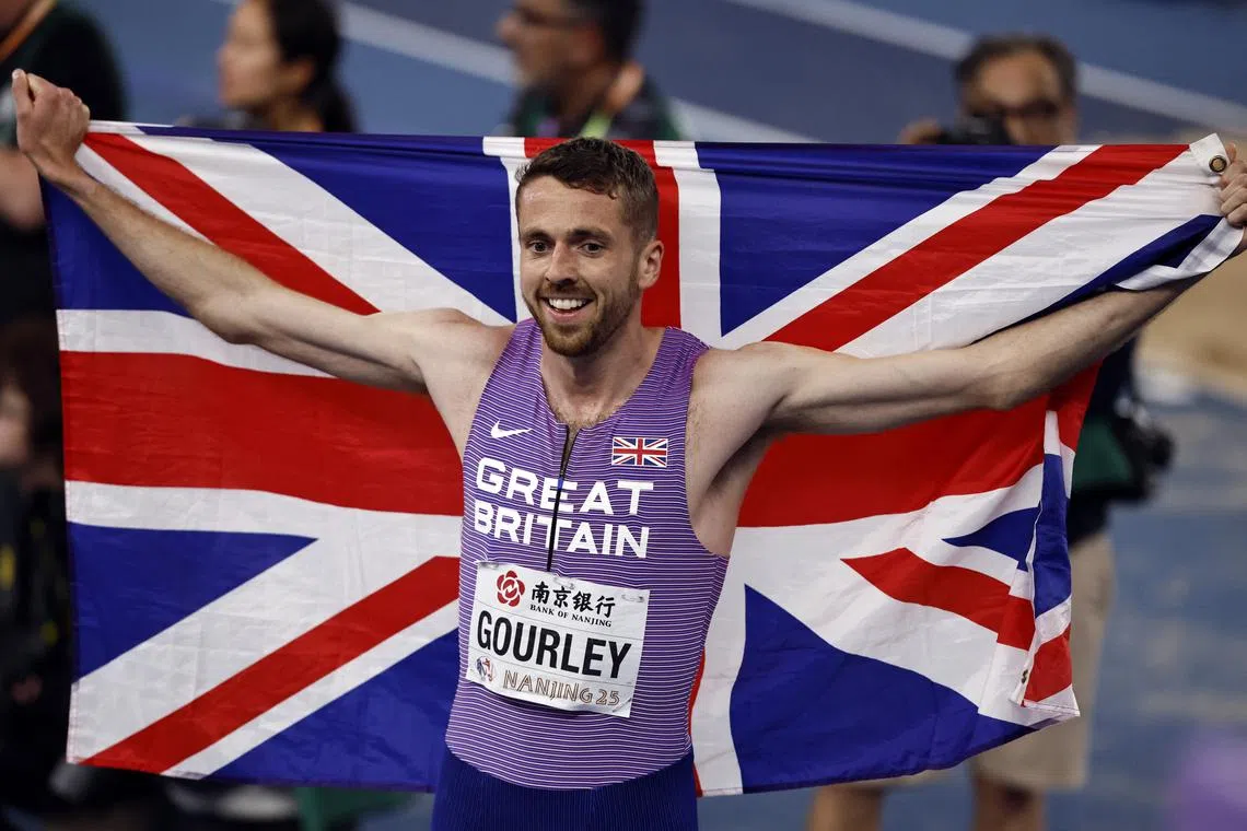 FILE PHOTO: Athletics - World Athletics Indoor Championships - Nanjing Youth Olympic Sports Park, Nanjing, China - March 23, 2025 Britain's Neil Gourley celebrates with his national flag after finishing second in the men's 1500m final REUTERS/Tingshu Wang/File Photo